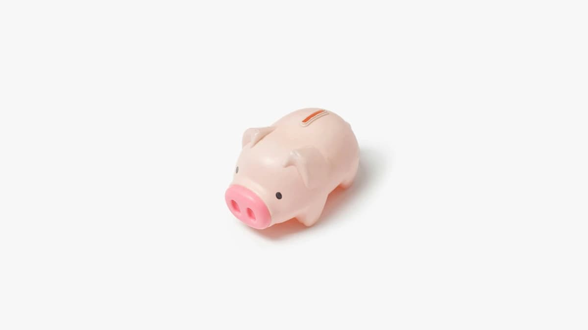 Small piggy bank sitting alone on a plain background